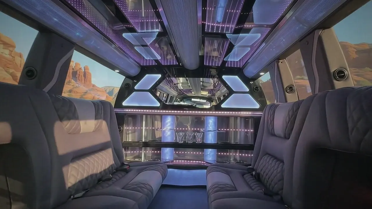 Inside the Cadillac Escalade limo in Cheyenne: LED light-show ceiling, leather lounge seating and lit bar